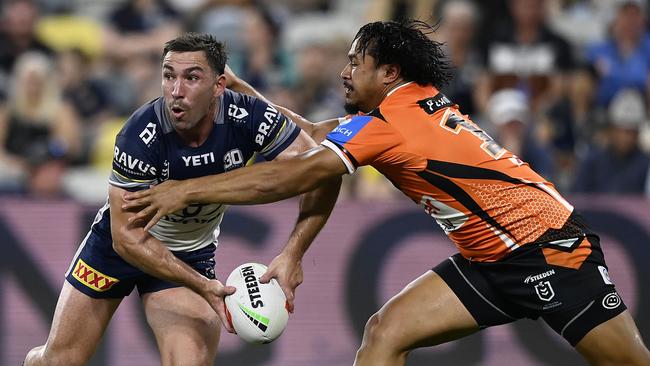 Reece Robson of the Cowboys is tackled by Sione Fainu of the Tigers during the round 13 NRL match between North Queensland Cowboys and Wests Tigers at Queensland Country Bank Stadium on May 31, 2025, in Townsville, Australia. (Photo by Ian Hitchcock/Getty Images)