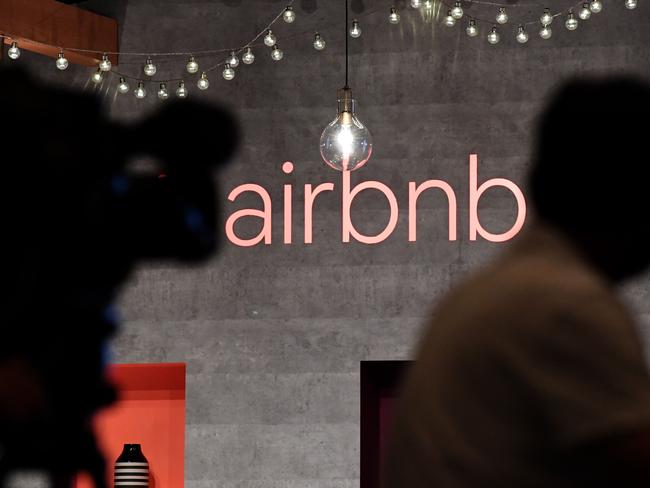 (FILES) In this file photo taken on June 13, 2018 shows US rental site Airbnb logo is displayed during the company's press conference in Tokyo. - "Sharing economy" firms like Uber and Airbnb were seeing surging growth and predictions they would reshape several economic sectors. Then the pandemic hit.  These companies are now bleeding more cash than ever, shedding workers and scaling back expectations for profitability amid heightened uncertainty about consumer trends and the economic outlook. (Photo by Toshifumi KITAMURA / AFP)