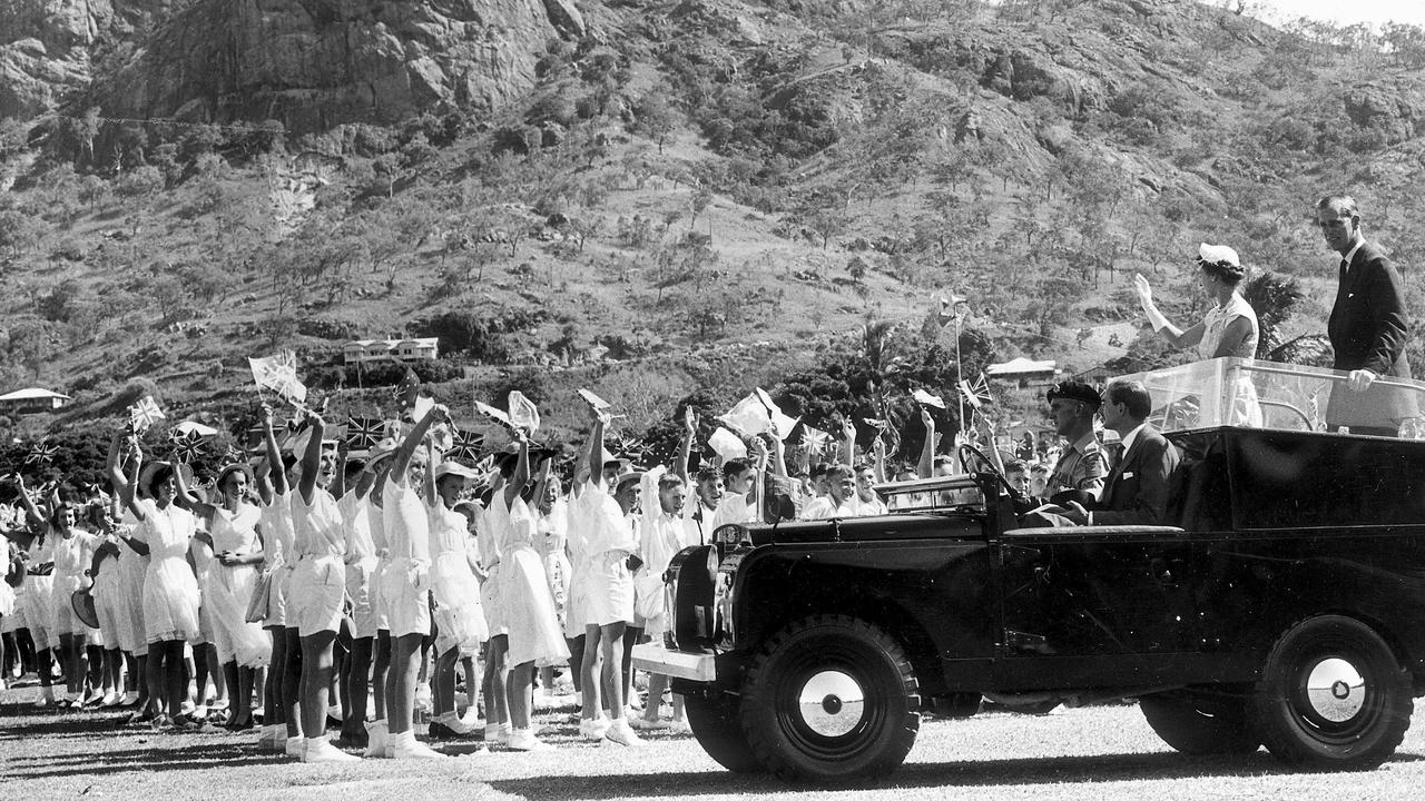 UPLOADED IMAGE - 1954 Royal Tour. The Royal Land Rover drives with Queen Elizabeth, past lines of school children at Townsville Sports Reserve under the shadow of castle hill. Prince Philip.