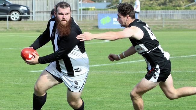 Claremont’s Jackson Simpson, left, tries to avoid a tackle from New Norfolk’s Rohan Thomason. Picture: David Harding