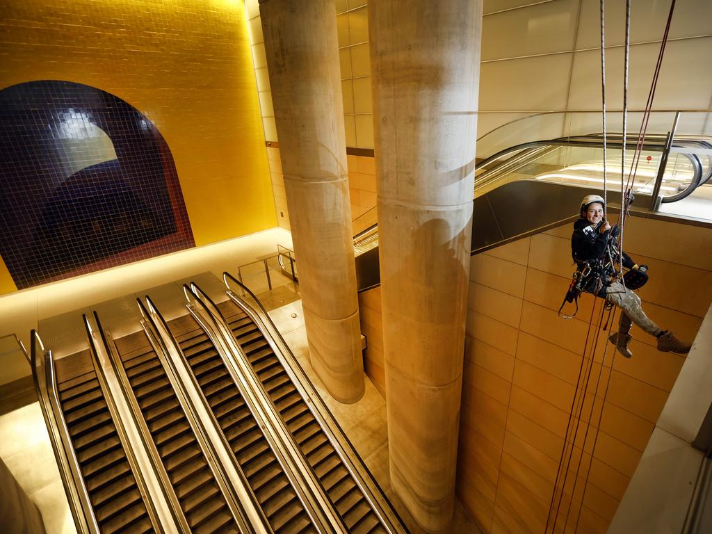 Sandra Castano, at the Gadigal Metro Station, doing some last minute cleaning of the sandstone along the Sydney Metro line. Picture: Richard Dobson