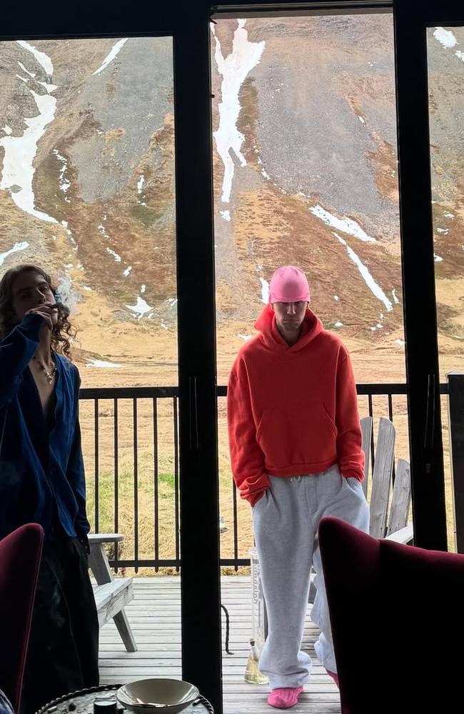 Justin Bieber poses next to a giant bong.