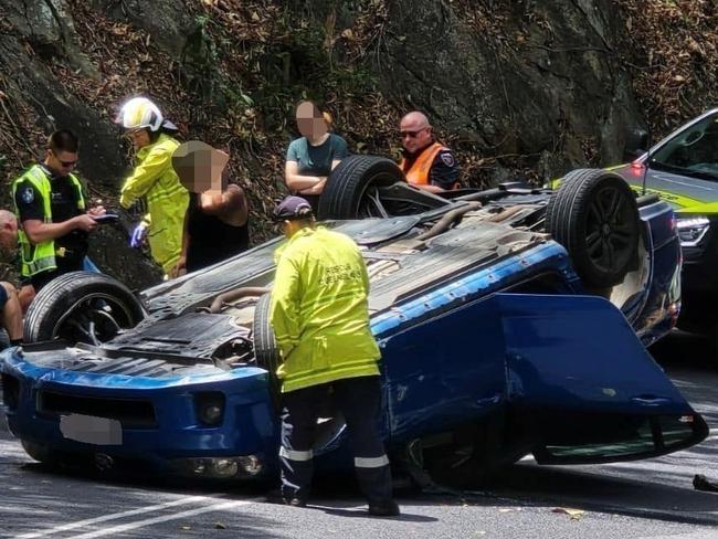 The Kuranda Range Rd was closed in both directions after a blue sedan has flipped onto its roof. Picture: Andrew Moss / Facebook