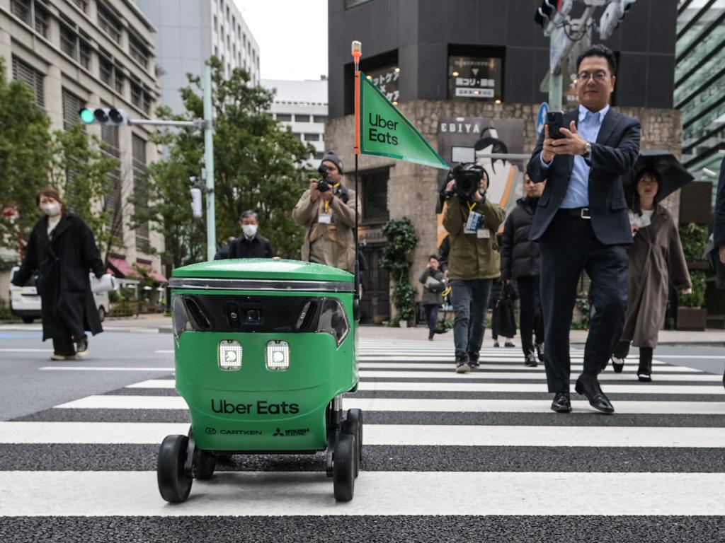 An unmanned robot by Uber Eats Japan navigates a street crossing during a delivery service demo. Picture: Richard A. Brooks/AFP