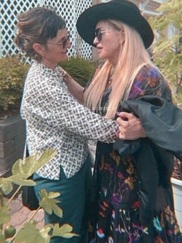 Madonna and Melanie embrace.