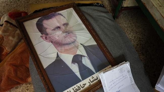 A portrait of Syrian President Bashar al-Assad lies broken in a Political Security Branch facility on the outskirts of the central city of Hama. Picture: AFP