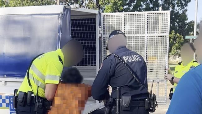 The 11-year-old boy is forced into the cage by armed police. He screams: ‘No, no, no, no!’