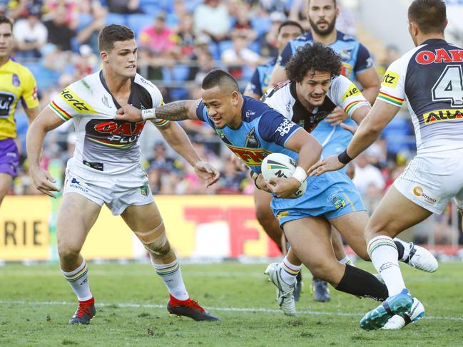 Phillip Sami of the Titans (centre) fends off a tackle from Corey Harawira-Naera (second right) and Nathan Cleary (left) of the Panthers during the Round 22 NRL match between the Gold Coast Titans and the Penrith Panthers at Cbus Super Stadium on the Gold Coast, Saturday, August 11, 2018. Picture: AAP Image/Glenn Hunt