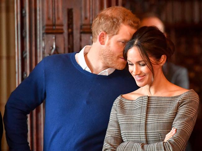 Prince Harry whispers to Meghan Markle as they watch a performance by a Welsh choir in the banqueting hall during a visit to Cardiff Castle on January 18, 2018 in Cardiff, Wales. Picture; Getty