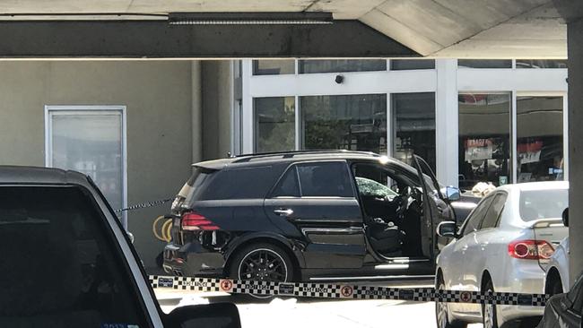 A black Mercedes 4WD sits in the car park outside Fitness First in Rockdale after a man was shot.