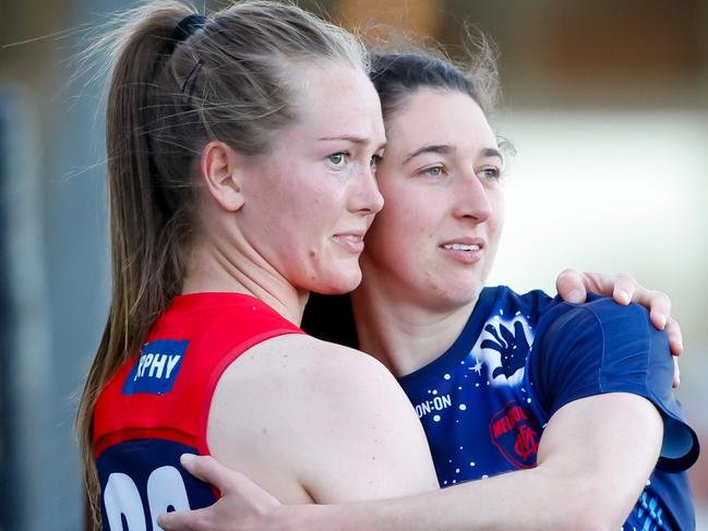 MELBOURNE, AUSTRALIA - SEPTEMBER 16: Teammates Eden Zanker and Alyssa Bannan of the Demons embrace during the 2023 AFLW Round 03 match between the Melbourne Demons and the Western Bulldogs at Casey Fields on September 16, 2023 in Melbourne, Australia. (Photo by Dylan Burns/AFL Photos via Getty Images)