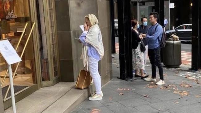 Christine Holgate waits outside the Hermes store at the corner of King and Castlereagh Streets in Sydney. Picture: Supplied