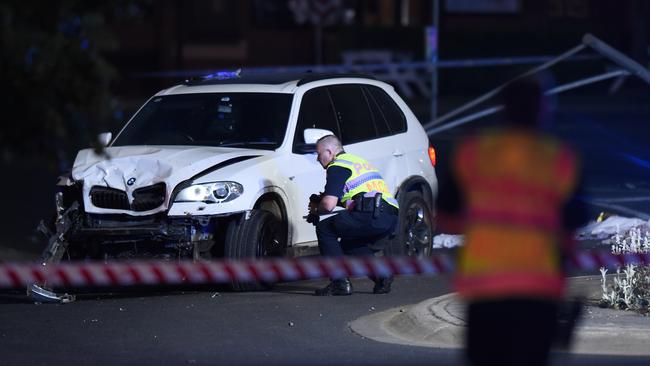 A police officer inspects a white BMX X5 close to the Royal Daylesford on Sunday evening. Picture: NCA NewsWire / Josie Hayden