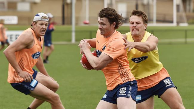 Tackling machine Tom Atkins attempts to bring down start team-mate Patrick Dangerfield.