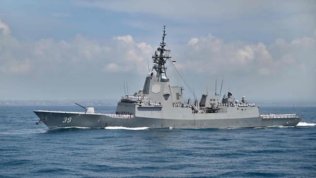 Personnel onboard the Australian Navy's HMAS Hobart salute during the opening ceremony of the 5th Multilateral Naval Exercise Komodo 2025 in Denpasar on Indonesia's resort island of Bali on February 16, 2025. (Photo by SONNY TUMBELAKA / AFP)