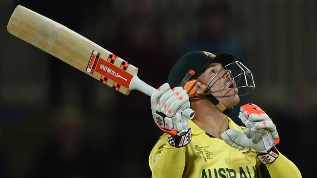 Australian cricketer David Warner follows the ball after playing a shot at the Bellerive Oval during the 2015 Cricket World Cup Pool A match between Australia and Scotland in Hobart on March 14, 2015. AFP PHOTO / INDRANIL MUKHERJEE -- IMAGE RESTRICTED TO EDITORIAL USE - STRICTLY NO COMMERCIAL USE--