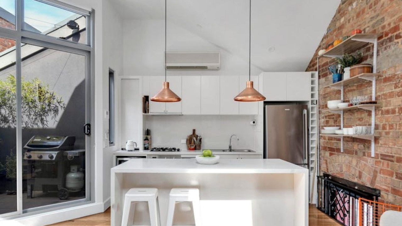 A waterfall-style island bench takes centre stage in the kitchen.