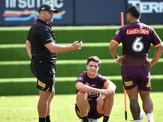 Anthony Seibold (left) talks to his struggling halves. Picture: AAP