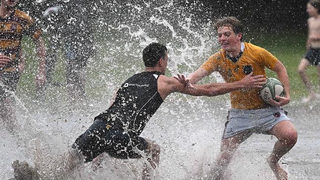 Locals play a game of rugby league on a flooded oval in Rosalie, Brisbane, following ex-cyclone Alfred. Picture: Lyndon Mechielsen