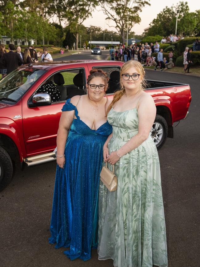 Rhianah Haworth (left) and Sophie Berghofer arrive at Harristown State High School formal at Highfields Cultural Centre, Friday, November 18, 2022. Picture: Kevin Farmer