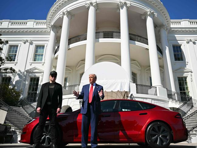 US President Donald Trump and Tesla CEO Elon Musk speak to the press as they stand next to a Tesla vehicle on the South Portico of the White House on March 11, 2025 in Washington, DC. (Photo by Mandel NGAN / AFP)