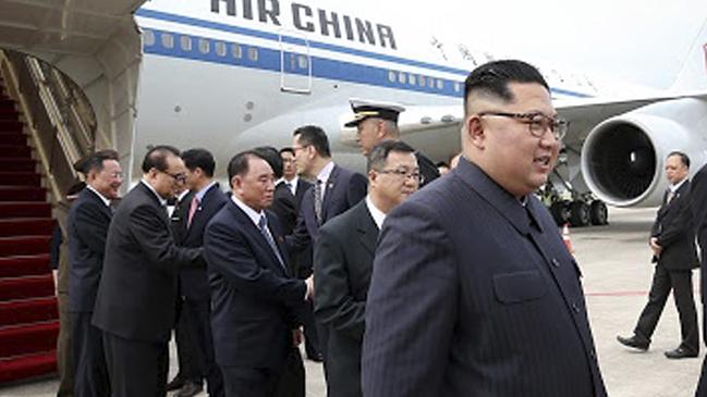 North Korean leader Kim Jong-un, right, arrives at the Changi International Airport. Picture: AP