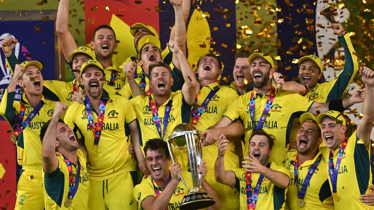 Australia's players celebrate with the trophy. Photo by Money SHARMA / AFP-