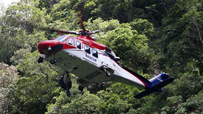 The QGAir helicopter has been unable to land at the South Johnstone River location to retrieve the body of the deceased man due to harsh weather conditions. Picture: Stewart McLean