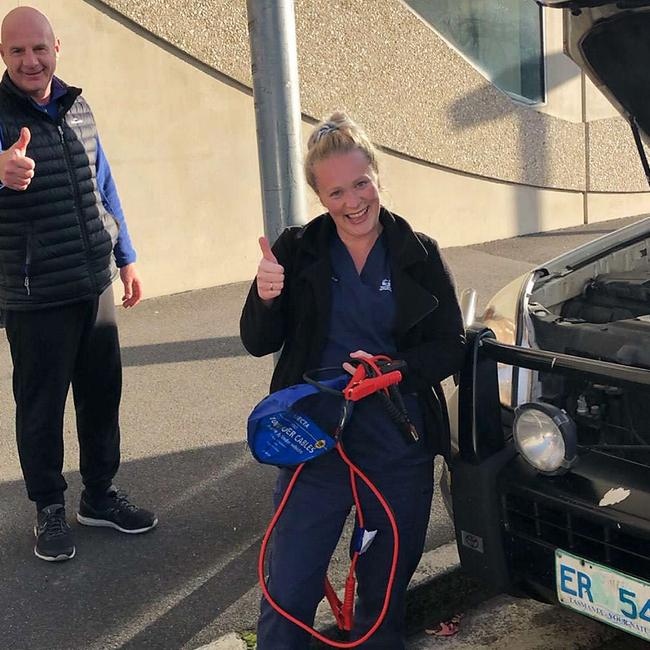 Premier Peter Gutwein poses with Royal Hobart Hospital nurse Sophie Williams after helping jump start her car.