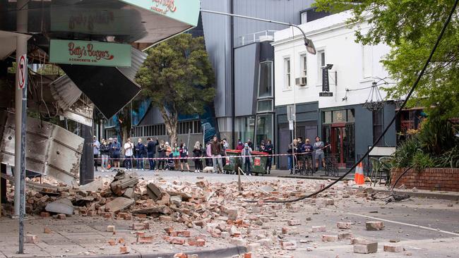 Debris litters Chapel Street, Windsor, after the quake partially demolished a burger shop. Picture: Mark Stewart