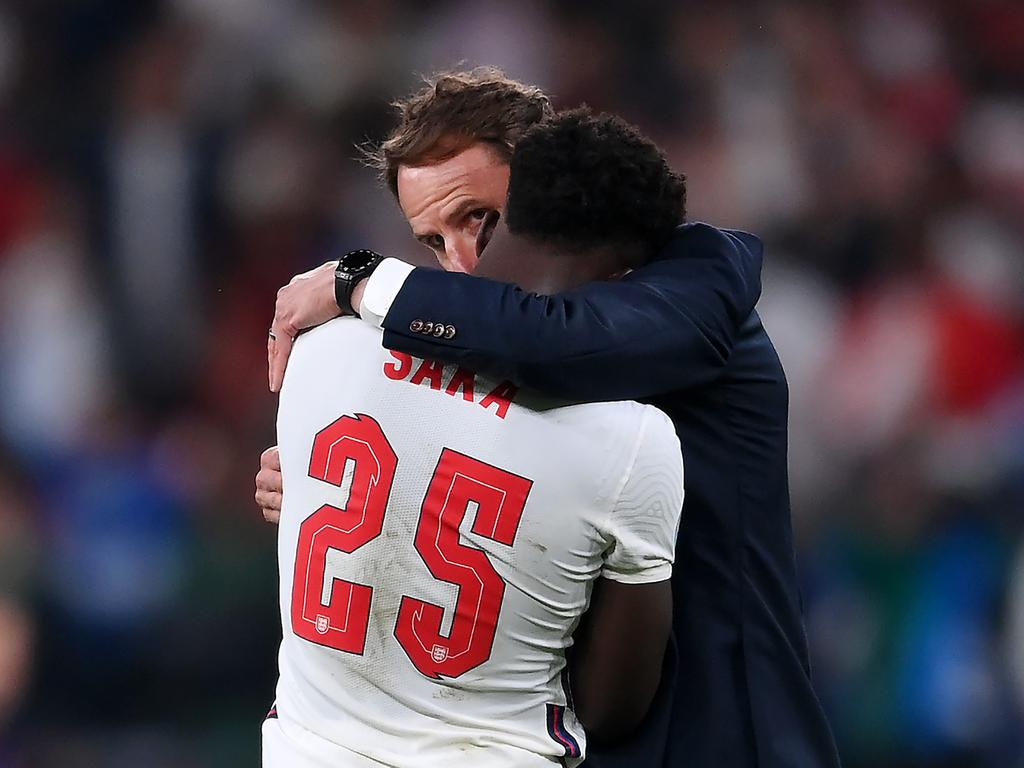 Bukayo Saka is consoled by coach Gareth Southgate after his penalty miss.