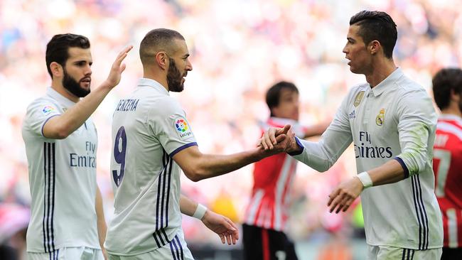Real Madrid's French forward Karim Benzema (C) is congratulated by Cristiano Ronaldo.