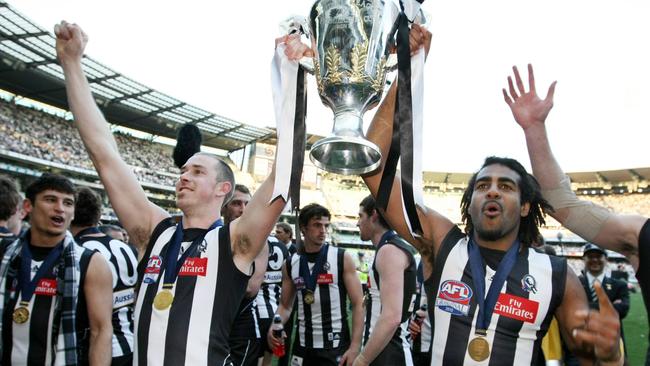 Nick Maxwell and Heritier Lumumba hold the premiership cup to supporters.