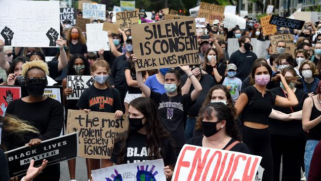 Peaceful demonstrators hold signs as they protest the death of George Floyd in Bethesda, Maryland.