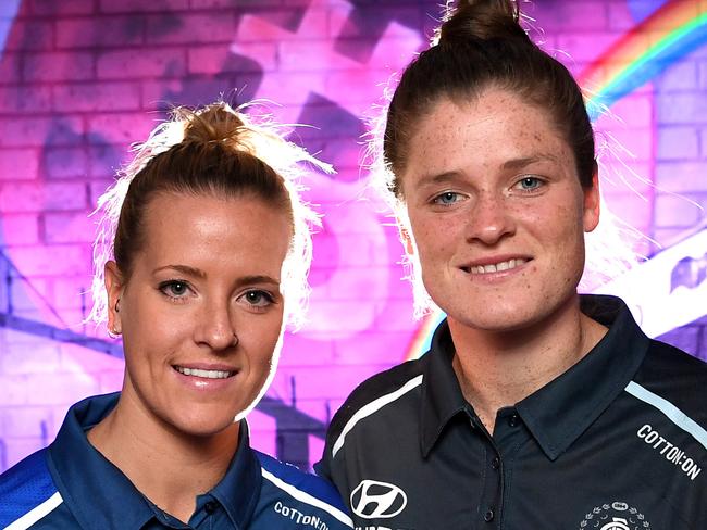 AFLW players Hannah Scott from the Western Bulldogs (left) and Brianna Davey from Carlton (right) pose for a photograph at the 'Pride of our Footscray' bar in Melbourne, Wednesday, February 7, 2018. The sides announced their round 4 match, will be their Pride round match. (AAP Image/Joe Castro) NO ARCHIVING