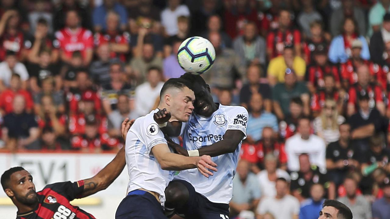 Everton's Michael Keane centre left and teammate Idrissa Gueye clash heads as they vie for the ball