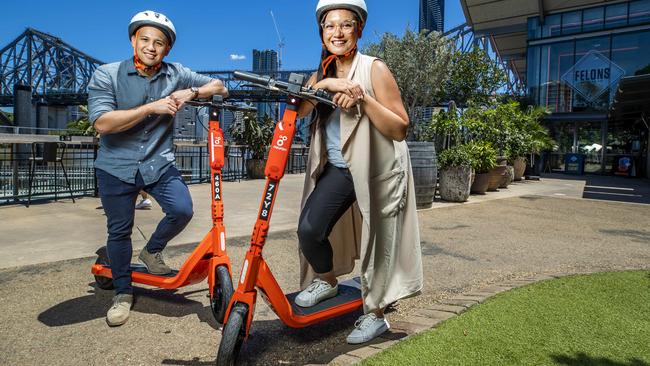 Lorenz Villalba from Bowen Hills (left) and Jairaldine Cruz from Springfield (right) scooting at Howard Smith Wharves - Brisbane’s top e-scooter spot. Picture: Richard Walker