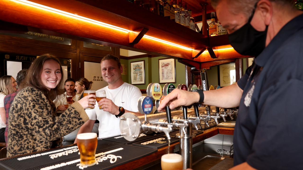 The Fortune of War pub in the Rocks pours Sydney's first post-lockdown beers to Darcie Hill and Michael Cody. Picture: Damian Shaw