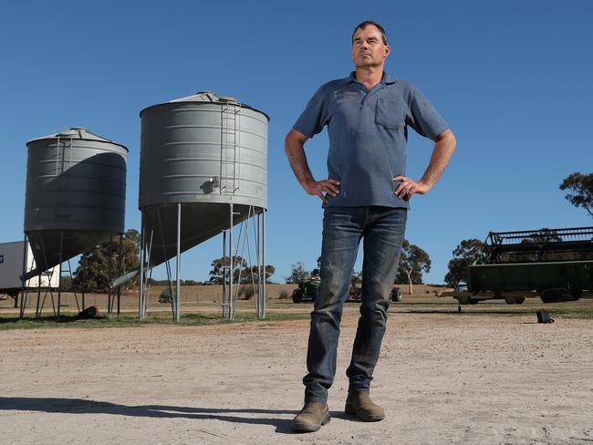 President of the Western Australian Farmers Federation and mixed grains farmer Rhys Turton poses for a photograph next to his barley seed silos near York in the Wheatbelt region, 100km east of Perth on Tuesday, May 19, 2020. China today imposed an 80% tariff on barley imports from Australia. Barley usually makes up about 30% of his total crop but he will now be substituting most of his barley for other grains. (AAP Image/Richard Wainwright) NO ARCHIVING