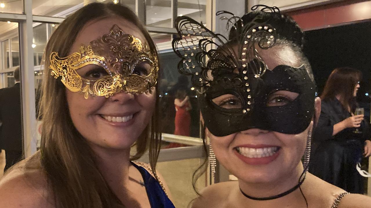 Emily Santowski and Kirstin McBride celebrate at the Gympie RSL Masked Ball, April 29 2023.