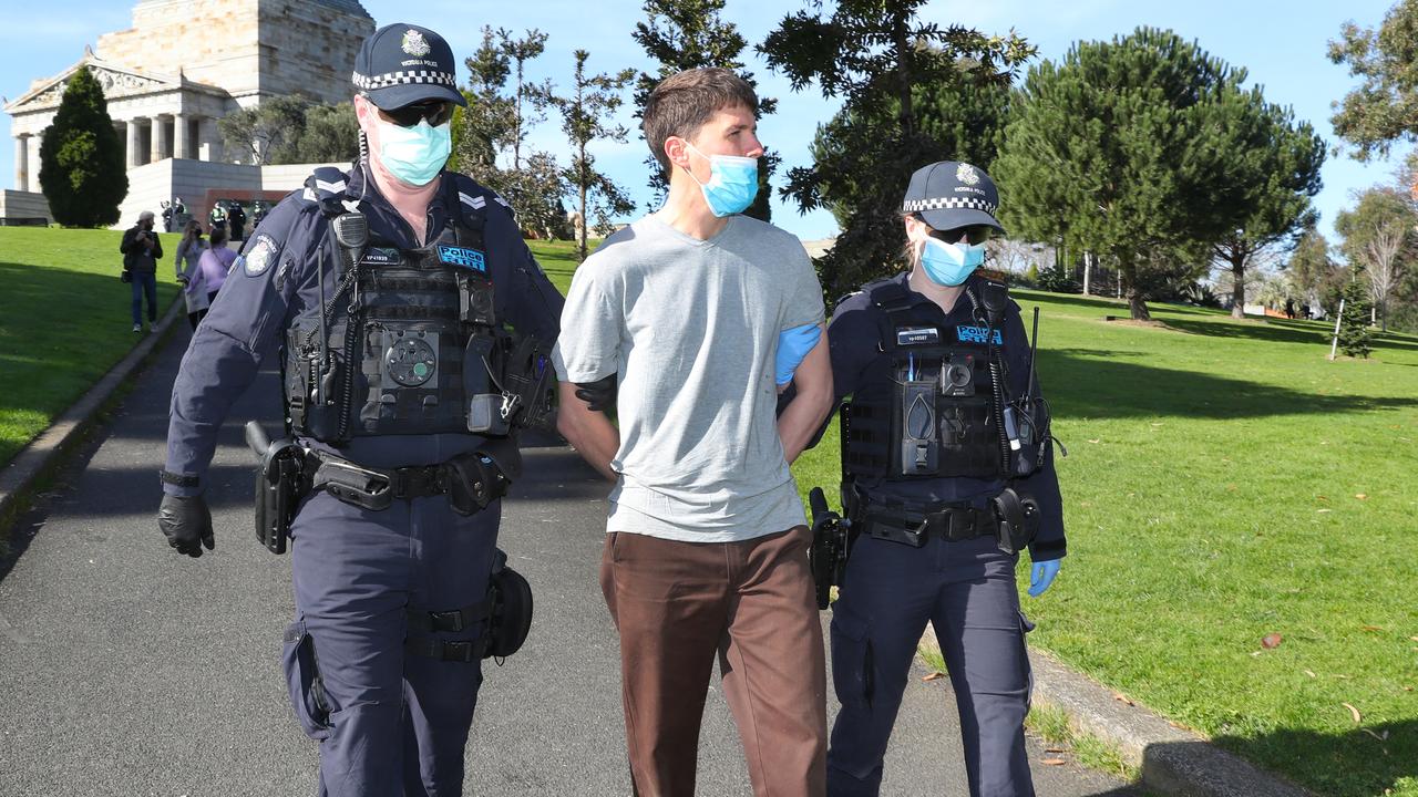 Police arrest a man after he refused to put on a mask at the Shrine of Remembrance earlier in the morning. Picture: NCA NewsWire /David Crosling