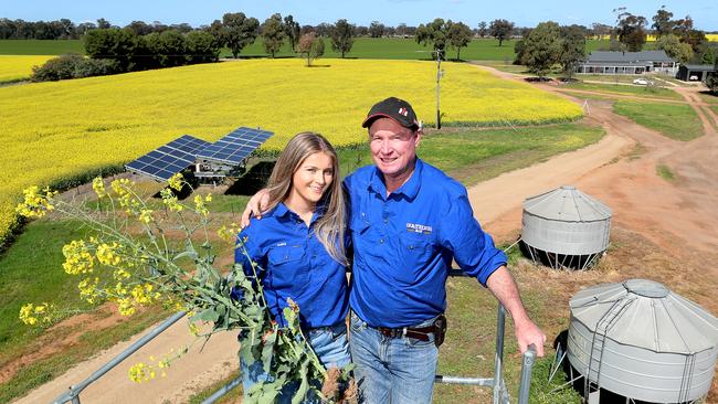 Tim Dowling and his daughter Gaby with their canola crop at Mulwala. Picture: Yuri Kouzmin