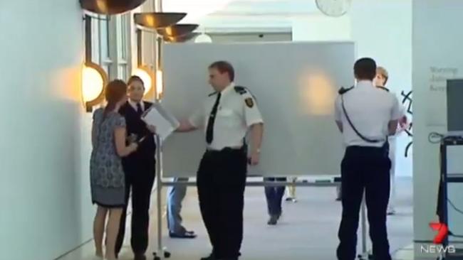 Michaelia Cash, right, walks behind the whiteboard as she arrives at Senate estimates on Thursday.