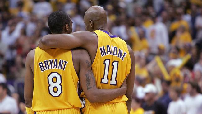 Kobe Bryant #8 and Karl Malone #11 of the Los Angeles Lakers walk downcourt in Game six of the Western Conference Finals against the Minnesota Timberwolves in 2004.