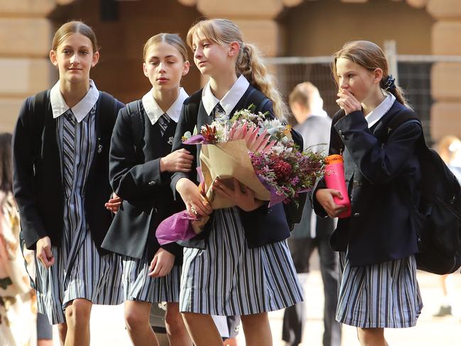 St Andrew's Cathedral School students drop off flowers as they return to school for the first time since Lilie’s death. Picture: Rohan Kelly