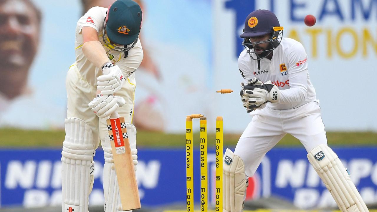 Australia's Travis Head (L) is bowled out in Galle on July 11, 2022. Photo: AFP