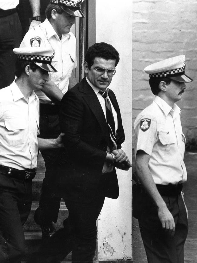 Alekos Tsakmakis leaving the coroners court at Hawthorn under police escort, 1986. Picture: Photo File