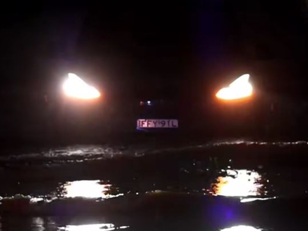 Footage has captured the moment a Tesla became trapped in floodwaters in Port Macquarie, as wild weather conditions batter the region. Picture: Adam Dederer