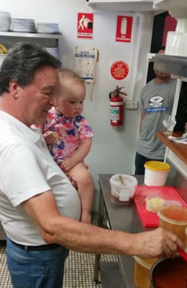 Mr Russich showing his granddaughter Eve her way around the kitchen.