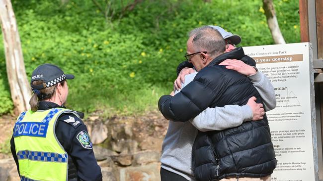 Witnesses consoled each other in the Morialta car park on Saturday morning. Picture: Keryn Stevens